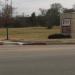Entrance Sign for Campus Village and The Woodlands in College Station, Texas city